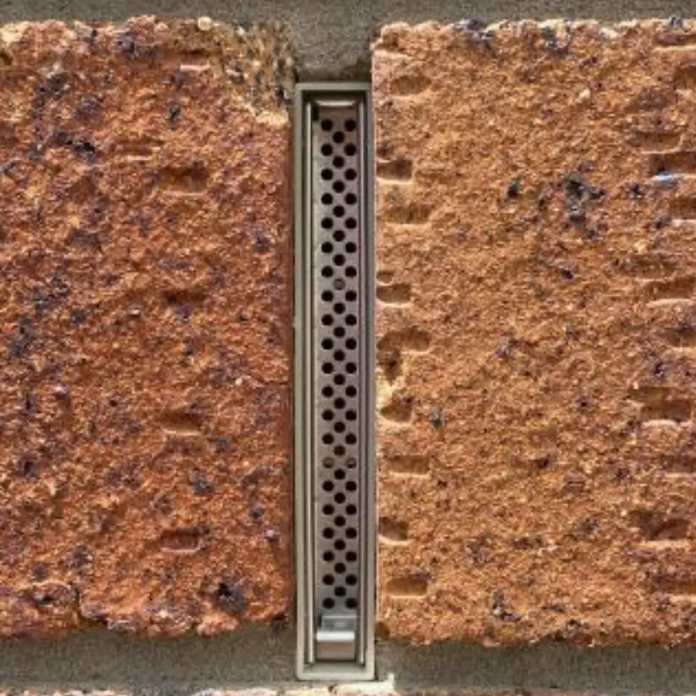 Weep vents installed in a brick wall